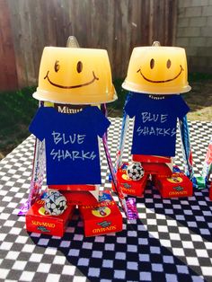 two yellow and blue boxes sitting on top of a black and white checkered table