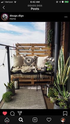 a wooden bench sitting on top of a balcony next to plants and potted plants