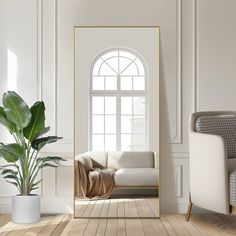 a living room with a couch, chair and large mirror on the wall next to a potted plant