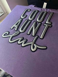 the words cool and fun are on top of a purple table