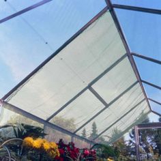 the inside of a greenhouse with plants and flowers