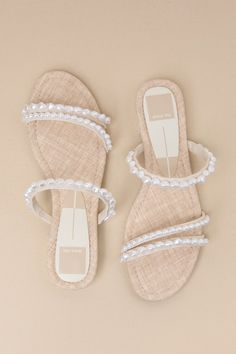 For everything from casual daytime looks to gorgeous evening events, we love the Dolce Vita Tinker Low Heel Pearl Vanilla Strappy Slide Sandals! These darling sandals have a woven footbed, with an almond-shaped toe and two slender toe straps decorated with organically-inspired faux pearl beads. Matching vamp strap completes the strappy effect. Easy, slide-on design. 0. 75" rubber heel. Rubber sole has nonskid markings. Lightly cushioned insole. Man made materials. Imported. Lulus | Tinker Low He Sandals With Pearls, Wineries Outfit, Pearl Sandals, Greek Wedding, Almond Shaped, Hoco Dresses, Rubber Heels, Low Heels, Slide Sandals