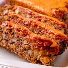 two slices of meatloaf on a white plate