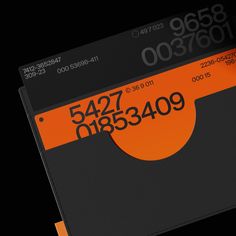 an orange and black credit card with the number 547 on it's side