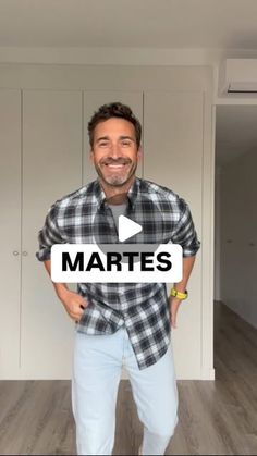 a man standing in front of a white wall with the words martes on it