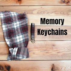 the words memory keychains are placed next to a pair of jeans on a wooden surface