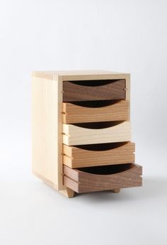 three wooden drawers stacked on top of each other in front of a white background,