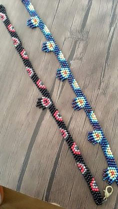 two bracelets made out of beads on a table