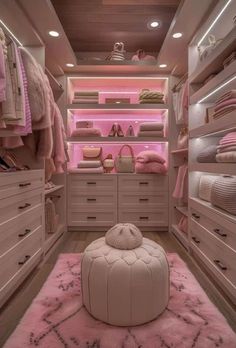 a walk in closet filled with lots of drawers and pink carpeted flooring on top of