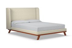 an upholstered bed with white linens and wood legs, on a white background