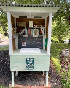 a small wooden bench with a chalkboard on the side and bookshelf in the back