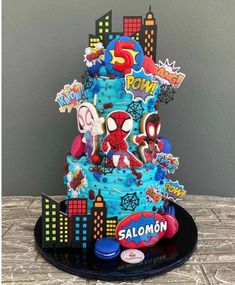 a spiderman themed birthday cake on a table