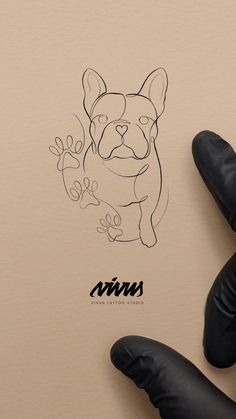 a drawing of a dog on top of a piece of paper next to black gloves