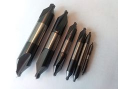 four different types of pens lined up on a table