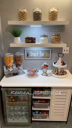 a snack bar with lots of snacks and drinks on the counter in front of it