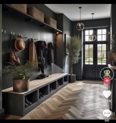 an entryway with coat racks, potted plants and shoes on the shelf next to it