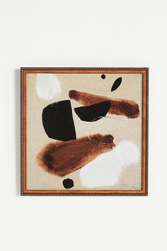 an abstract painting with brown and white colors on a beige background, hanging on a wall