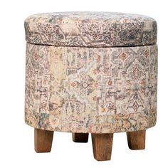 an upholstered ottoman with wooden legs and a floral pattern on the backrest