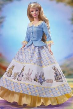 the doll is wearing a blue dress with white and yellow trims on it's skirt