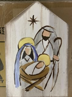 a nativity scene painted on the side of a wooden house with a star above it