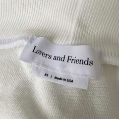 a label on a white shirt that says lovers and friends