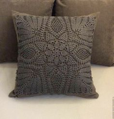 two gray pillows sitting next to each other on a bed