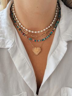 This pearl and gold bead necklace is your new favorite accessory this summer! Layer it with other fun necklaces for a fun and beachy look! Cheap Summer Pearl Necklace With Colorful Beads, Beaded Necklace Layering, Paperclip Necklace Layering, Strand Necklace With Beaded Chain For Vacation, Trendy Beaded Chain Jewelry For Vacation, Strand Beaded Chain Necklace For Vacation, Vacation Pearl Charm Strand Necklace, Vacation Strand Necklace With Beaded Chain, Vacation Strand Necklace With Pearl Charm