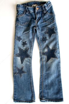 a pair of jeans with stars painted on them