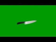 a knife is flying through the air on a green screen