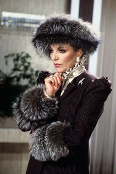 a woman in a suit and fur hat