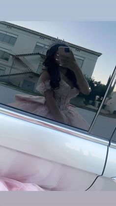 a woman taking a selfie in the back of a car