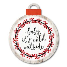 a wooden ornament that says baby it's cold outside