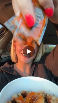 a woman is eating food out of a white bowl