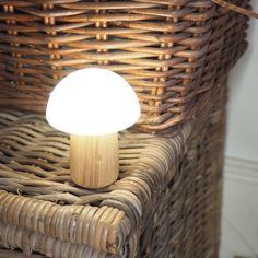 a mushroom lamp sitting on top of a wicker chair