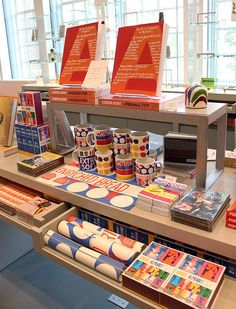 there are many books on the table and in front of it is a display case