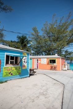 two colorful beach huts are next to each other