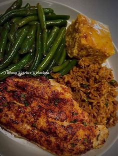 a white plate topped with chicken, rice and green beans