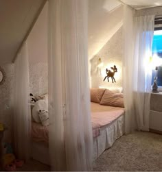 a bedroom with white curtains and pink bedding