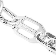 AMBUSH® began as an experimental line of jewelry – innovative pop art inspired designs capturing a distinct Tokyo aesthetic. The iconic trademarked POW!® motif in particular received media coverage around the world. With apparel created as a can-vas to complete the story, AMBUSH® evolved into designing unisex collections. Pictured is the Ambush Carabiner 1 Necklace in Silver. Brass composition Silver tone hardware Clasp fastening Engraved branding Style no: 12111855 Ambush Jewelry, Trouser Chain, Chrome Hearts Jewelry, Tokyo Aesthetic, Complete The Story, Media Coverage, 3d Artwork, Metal Keychain, Hot Nails