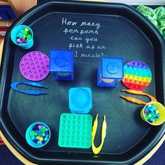 a black tray filled with plastic toys and writing on it