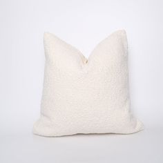 a white pillow sitting on top of a table