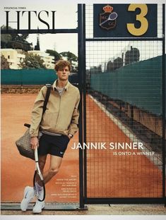 a man holding a tennis racquet while standing next to a fence on top of a tennis court