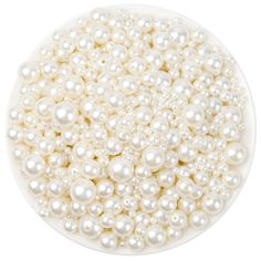 white pearls in a bowl on a white background