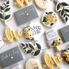 wedding cookies are arranged on the table for guests to sign their names and date cards