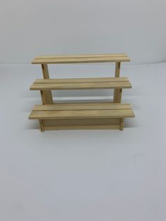 three wooden shelves sitting next to each other on a white surface with no one in the photo