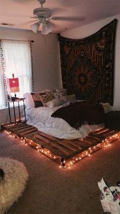 a bed made out of pallets with lights on it