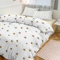 a bed with white sheets and yellow honeycombs on it