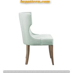 a white chair with wooden legs and a light green upholstered backrests