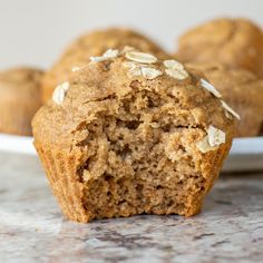 two muffins on a plate with one cut in half