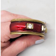 This is part of Chairish’s Costume Jewelry assortment.  1980s goldtone red enamel and round clear rhinestone slip on cuff bracelet. Marked "YOSCA©." Measures: 3/4 inches tall by 2 3/4 inches wide and 2 1/8 inches deep. Opening measures: 1 1/2 inches across. Interior circumference is about 6 1/2 inches. Condition: Exterior is in very good condition; interior has some darkening/discoloration. The matching clip earrings are also available for purchase. Chanel Cuff Bracelet, Blue Cuff Bracelet, Chanel Cuff, Black Cuff Bracelet, Rustic Cuff Bracelets, Gemstone Cuff Bracelet, Crystal Cuff Bracelet, Brass Cuff Bracelet, Rustic Cuff